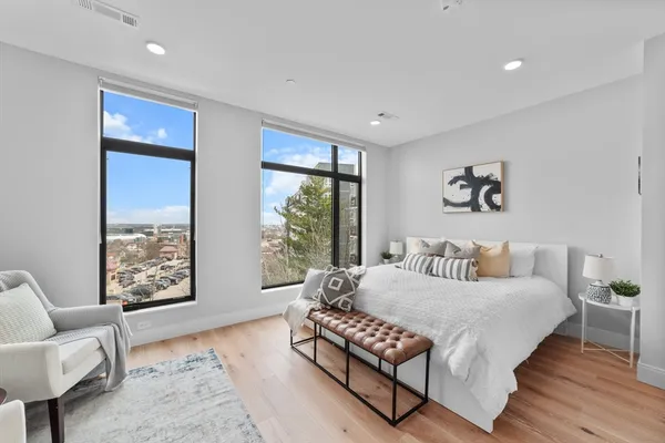 a bedroom with a bed and wooden floor