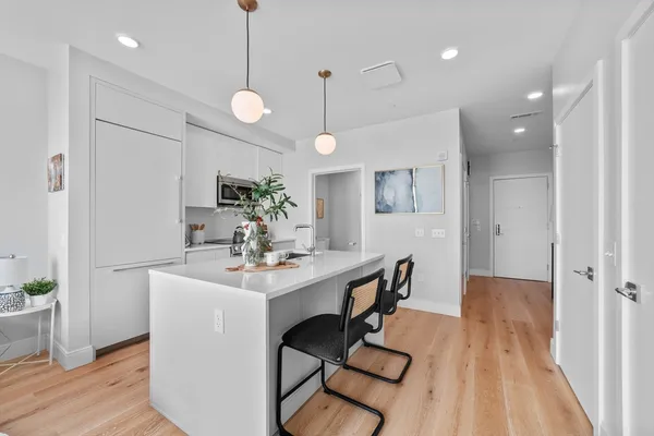 a view of a dining room with furniture wooden floor and chandelier