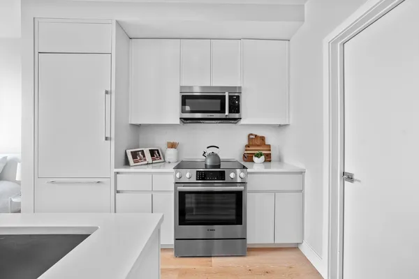 a kitchen with stainless steel appliances granite countertop a stove and a refrigerator