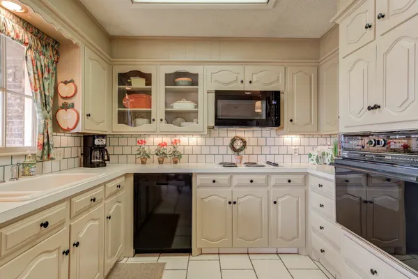 a kitchen with stainless steel appliances granite countertop a sink and cabinets