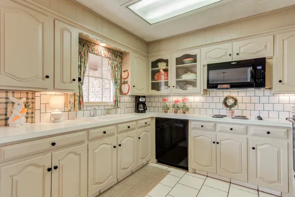 a spacious kitchen with cabinets stainless steel appliances and a sink