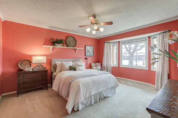 a bedroom with a bed dresser and a window