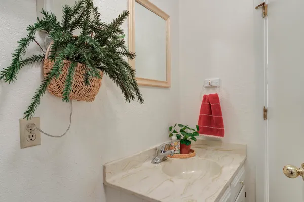 a bathroom with a sink a mirror and vanity