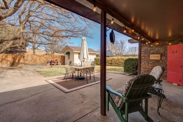 a view of a chairs and table in the patio