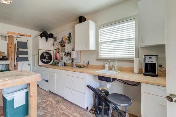 a kitchen with a sink a stove and a refrigerator