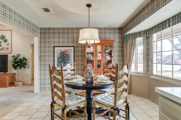 a dining room with furniture and window