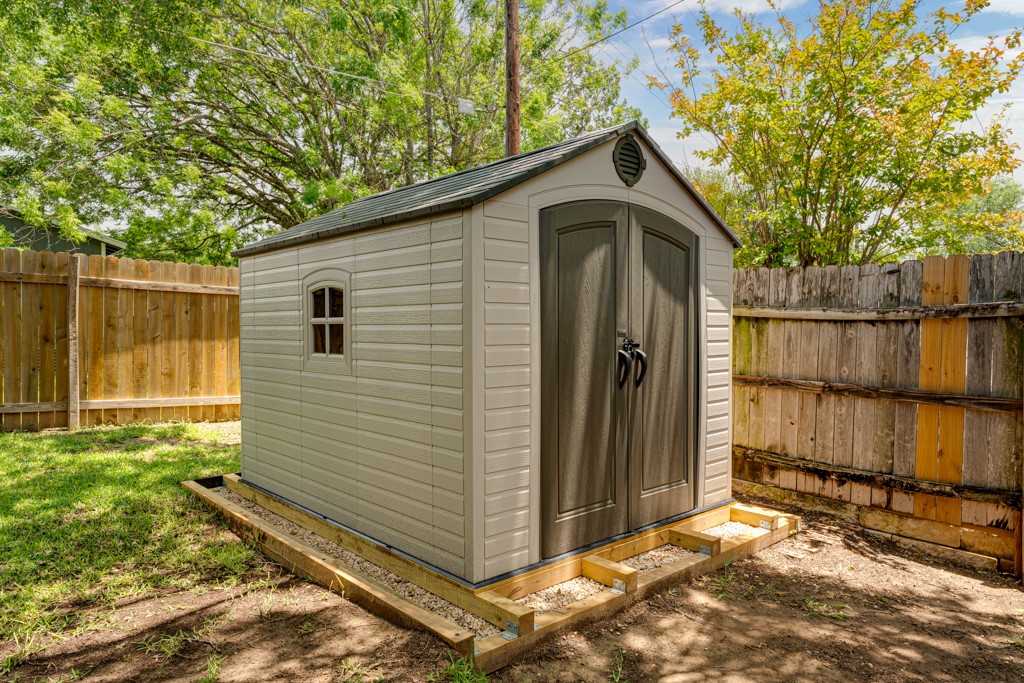 1502 Quail Run Road Pflugerville, TX 78660 - Photo 30 of 37 A detached storage shed with double doors and a window offers ample backyard utility.