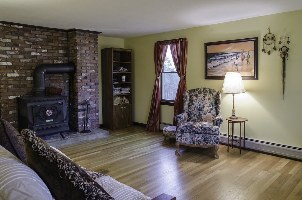 45 Sarah Sherman Road Rochester, MA 02770 - Photo 8 of 25 a living room with furniture and a fireplace