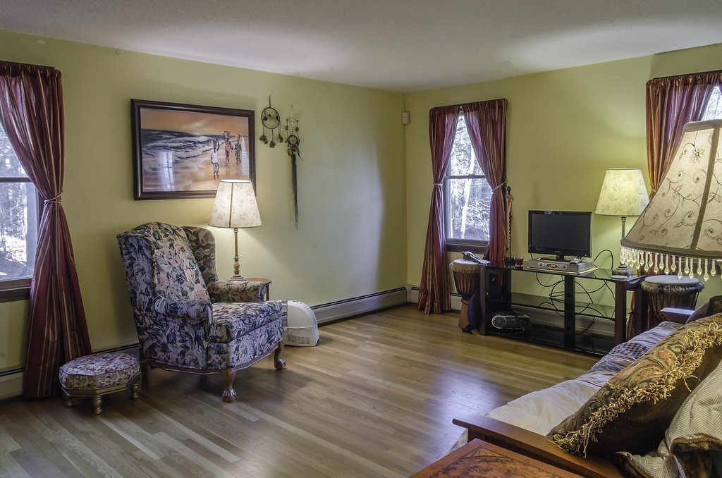 45 Sarah Sherman Road Rochester, MA 02770 - Photo 10 of 25 a living room with furniture and a flat screen tv