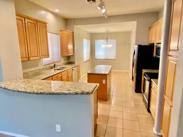a bathroom with a granite countertop sink a mirror and a shower