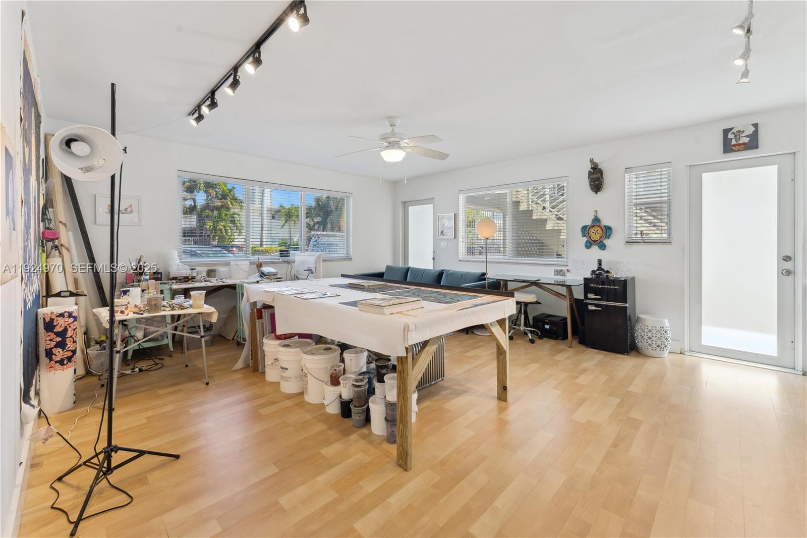7440 Byron Avenue, Unit 1B Miami Beach, FL 33141 - Photo 5 of 16 a living room with furniture a large window and wooden floor