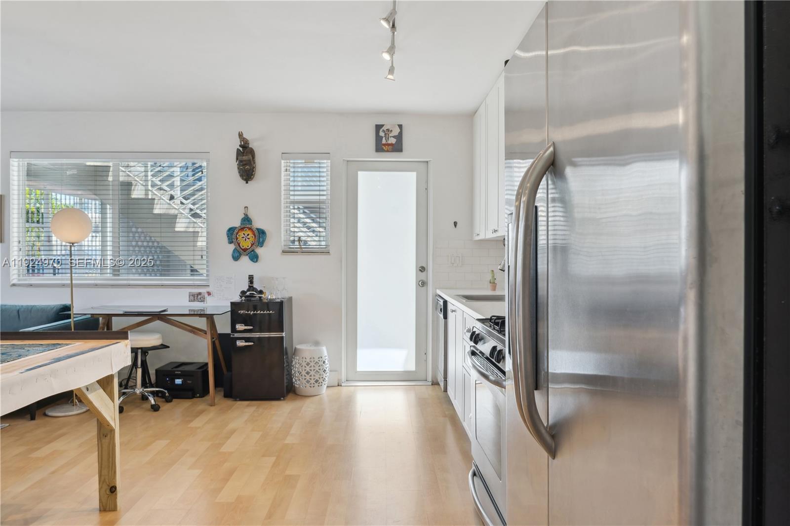 7440 Byron Avenue, Unit 1B Miami Beach, FL 33141 - Photo 7 of 16 a view of a workspace with furniture and a window