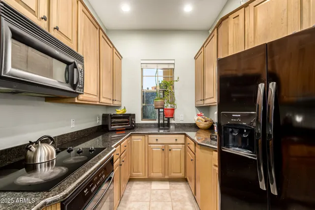 a kitchen with a sink and stainless steel appliances
