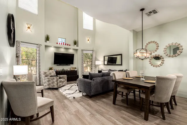 a living room with furniture a flat screen tv and a table