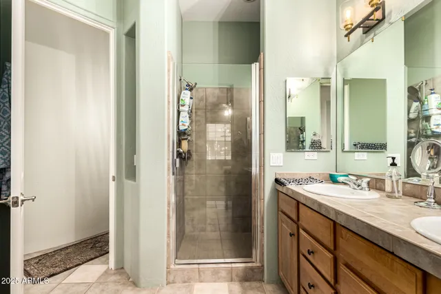 a bathroom with a shower sink and mirror
