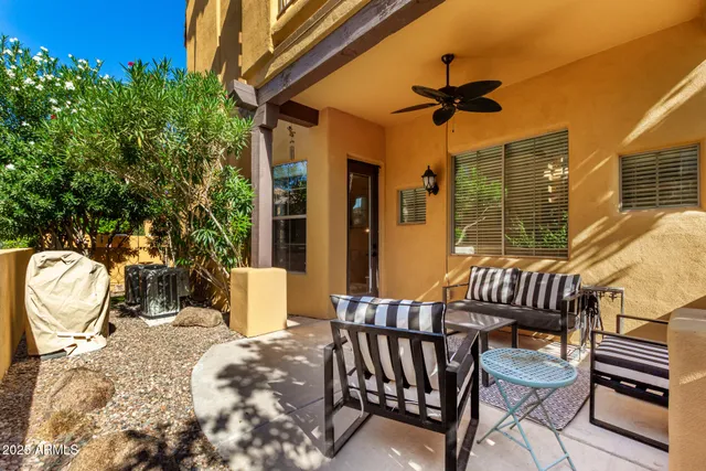 a view of a patio with a table and chairs