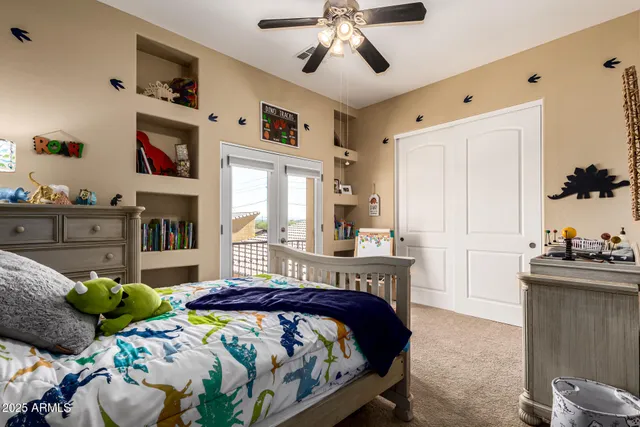 a bedroom with a bed dresser and flat screen tv
