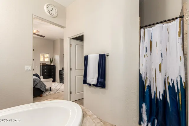 a bedroom with a bed and a large mirror