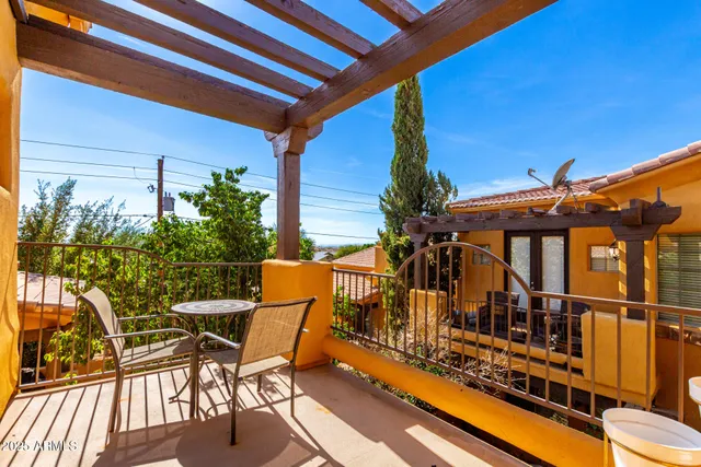 a view of a chairs and table in the balcony