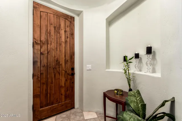 a view of front door with a chair and mirror