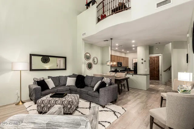 a living room with furniture and a dining table with kitchen view
