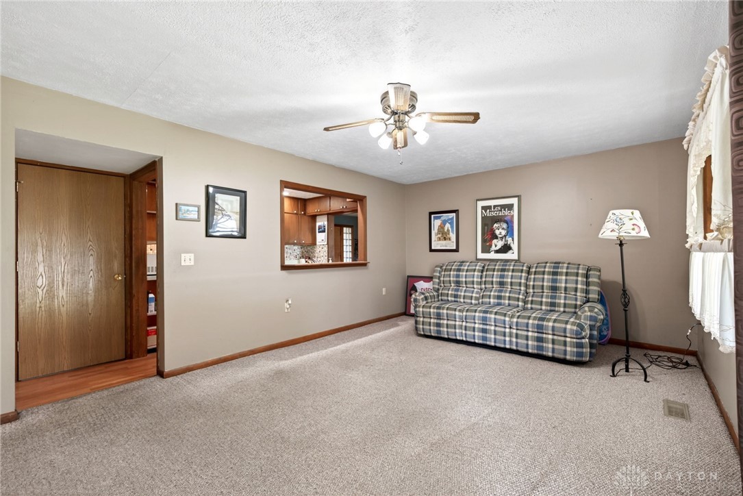 2470 Clark Run Road Xenia, OH 45385 - Photo 25 of 57 This inviting living space features comfortable carpeting and a convenient pass-through window to the kitchen.