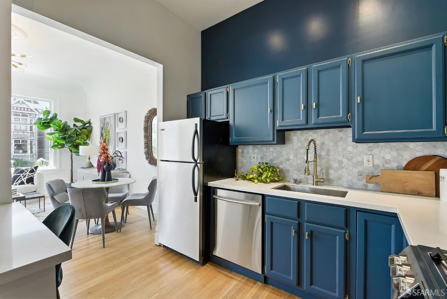 140 Divisadero Street, Unit 5 San Francisco, CA 94117 - Photo 11 of 32 a kitchen with stainless steel appliances granite countertop a refrigerator sink and cabinets