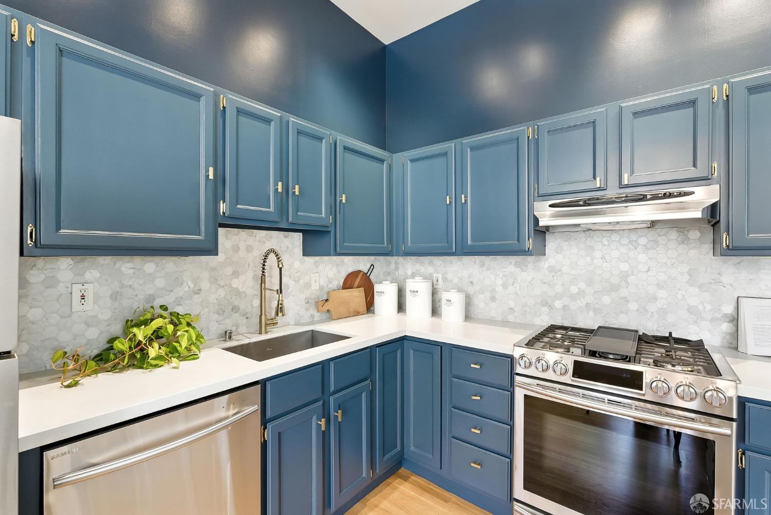 140 Divisadero Street, Unit 5 San Francisco, CA 94117 - Photo 13 of 32 a kitchen with stainless steel appliances granite countertop a sink stove and cabinets