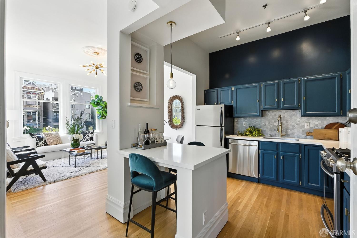 140 Divisadero Street, Unit 5 San Francisco, CA 94117 - Photo 2 of 32 a large kitchen with stainless steel appliances kitchen island granite countertop a sink and cabinets