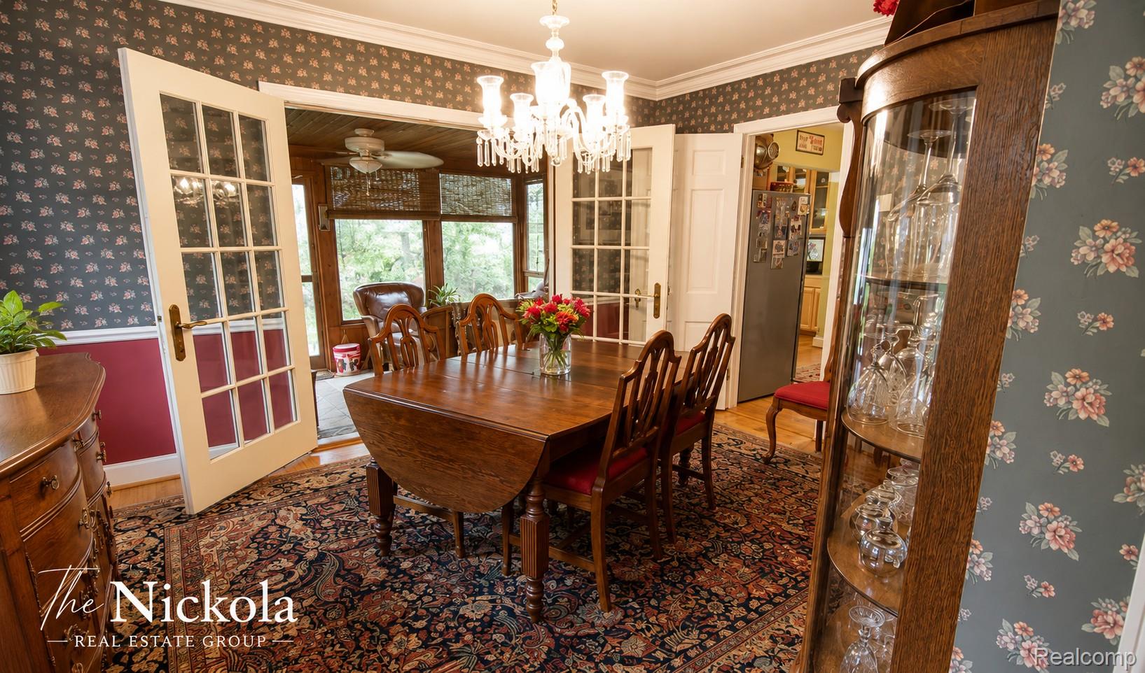 515 Barrington Road Detroit, MI 48215 - Photo 8 of 27 Dining room with wallpapered walls, wood finished floors, crown molding, hanging lights, and a ceiling fan