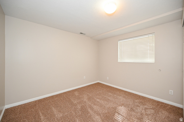 916 Vics Road, Unit 2 Sandy, UT 84094 - Photo 13 of 23 Carpeted room featuring neutral-toned walls, white baseboards, and a window with horizontal blinds