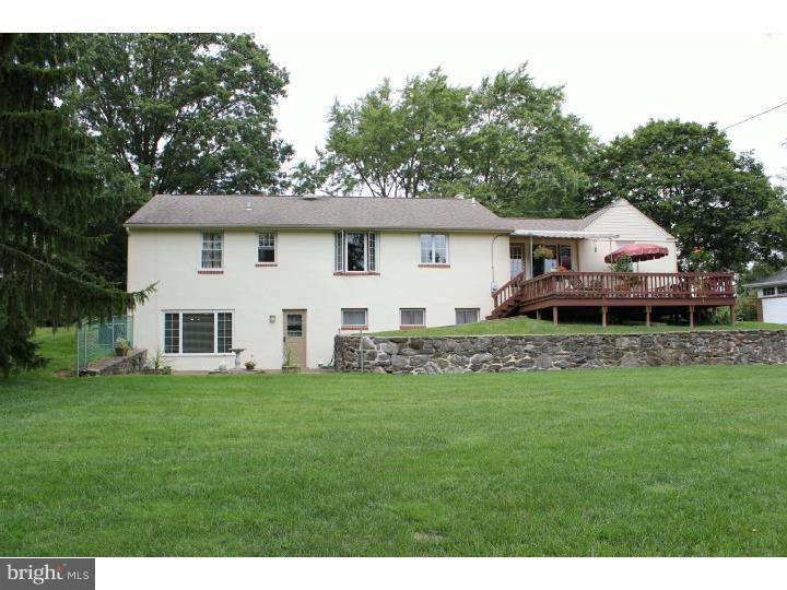 3410 Lewis Road Newtown Square, PA 19073 - Photo 18 of 23 a front view of a house with a garden