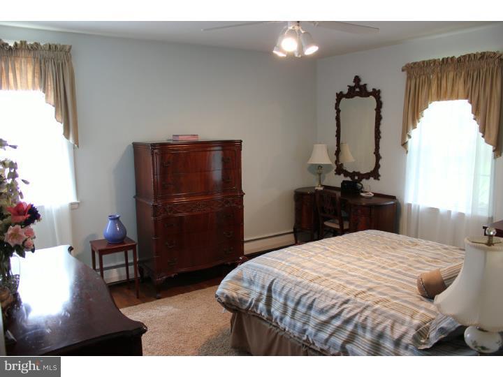 3410 Lewis Road Newtown Square, PA 19073 - Photo 10 of 23 a bedroom with a bed and a television