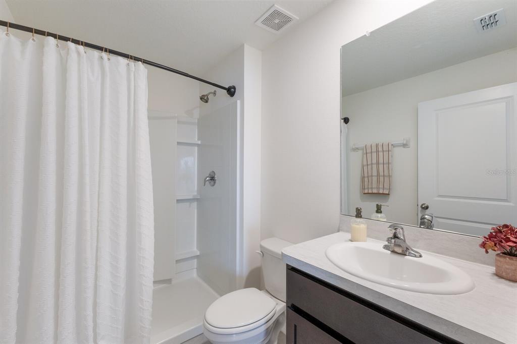 2938 Rock Sound Street Bradenton, FL 34208 - Photo 11 of 36 a bathroom with a sink a toilet and shower