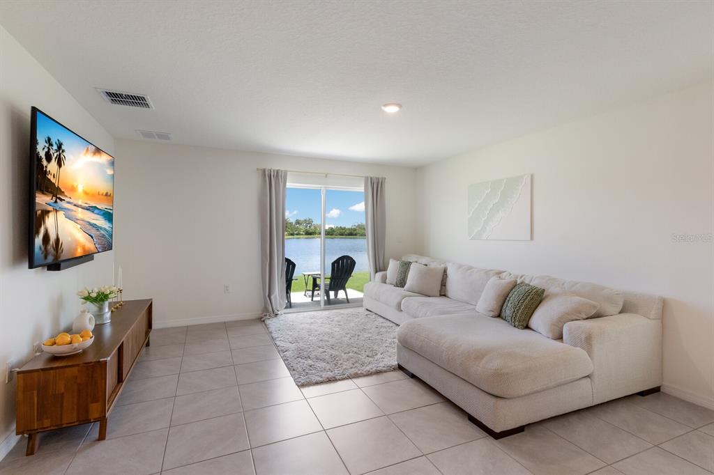 2938 Rock Sound Street Bradenton, FL 34208 - Photo 13 of 36 a living room with furniture and a flat screen tv
