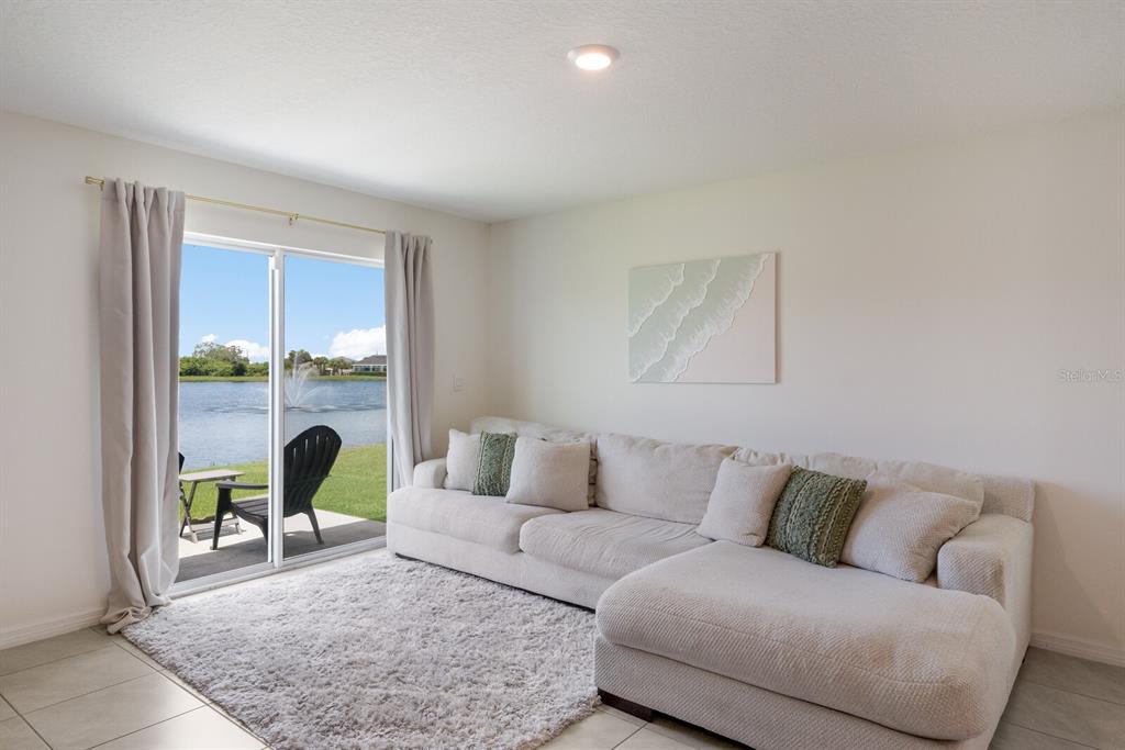 2938 Rock Sound Street Bradenton, FL 34208 - Photo 14 of 36 a living room with furniture and a large window