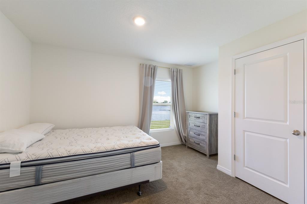 2938 Rock Sound Street Bradenton, FL 34208 - Photo 17 of 36 a bedroom with a bed and a window