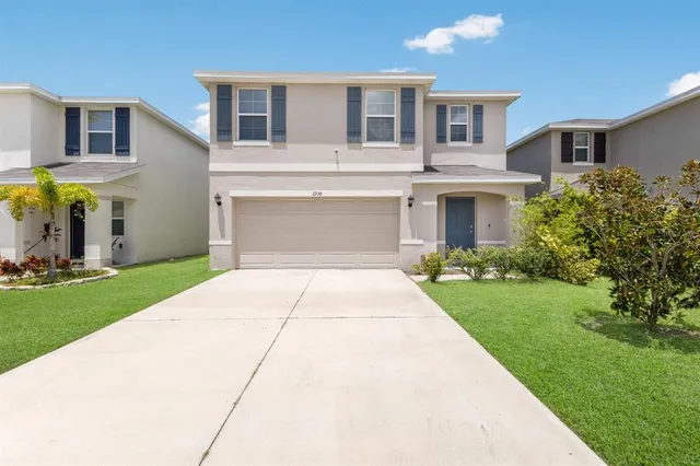 a front view of house with yard and green space