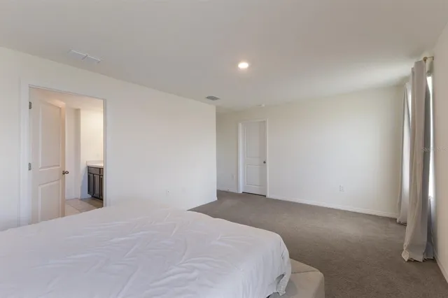 a bedroom with a bed and a mirror