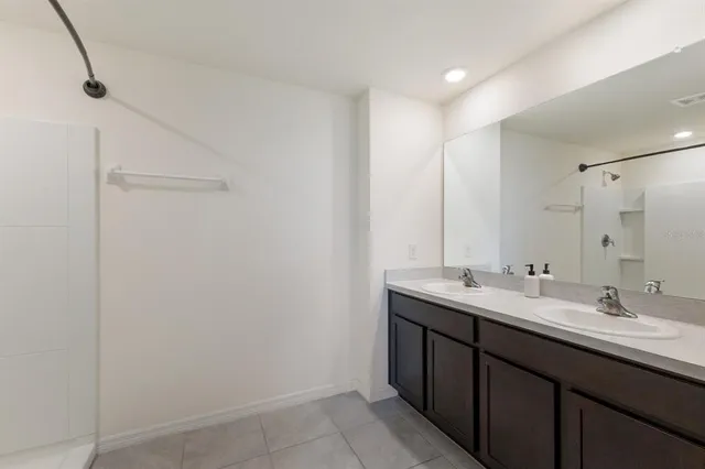 a bathroom with a double vanity sink and mirror