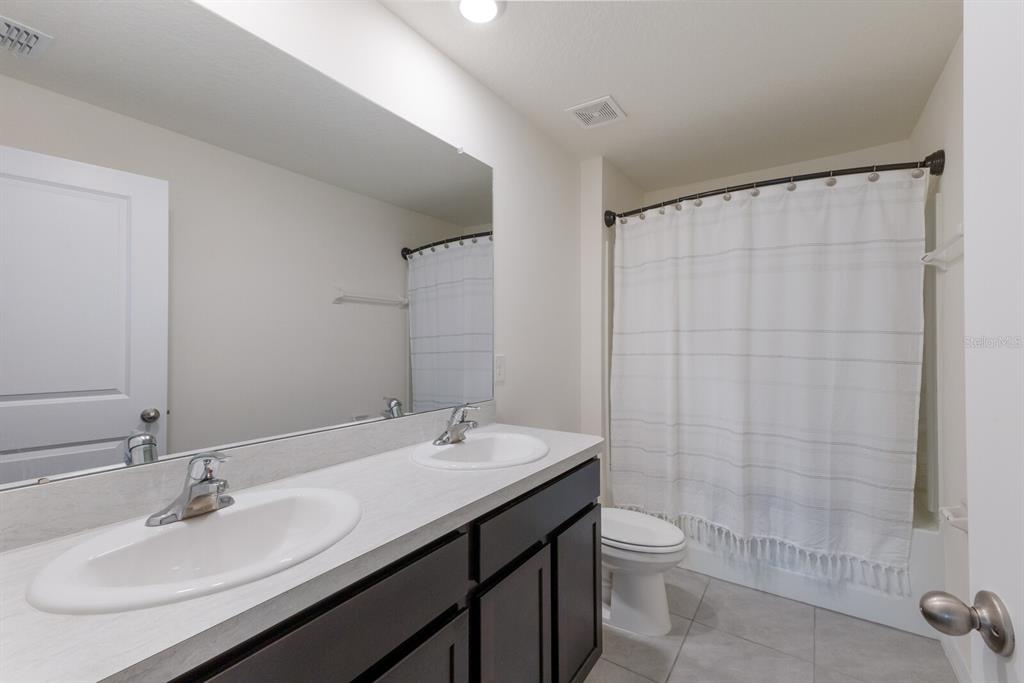 2938 Rock Sound Street Bradenton, FL 34208 - Photo 26 of 36 a bathroom with a sink a toilet and shower