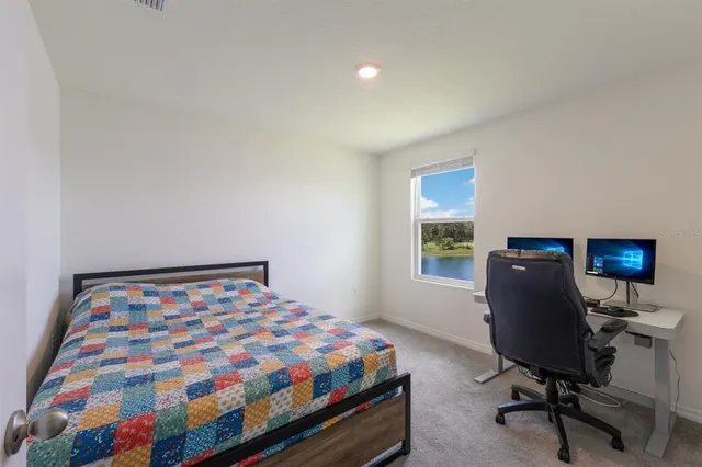 a bedroom with a bed and a desk