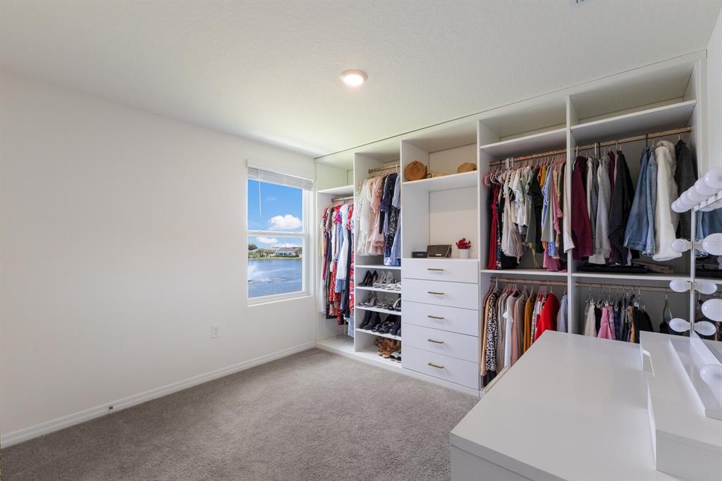 2938 Rock Sound Street Bradenton, FL 34208 - Photo 28 of 36 a view of walk in closet with clothes and shoes