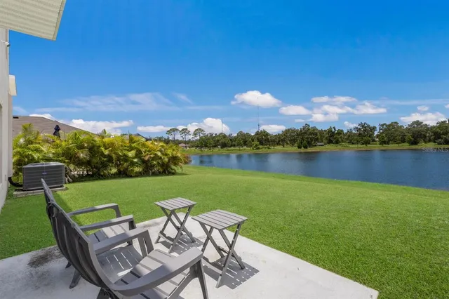 a view of a lake with a table and chairs