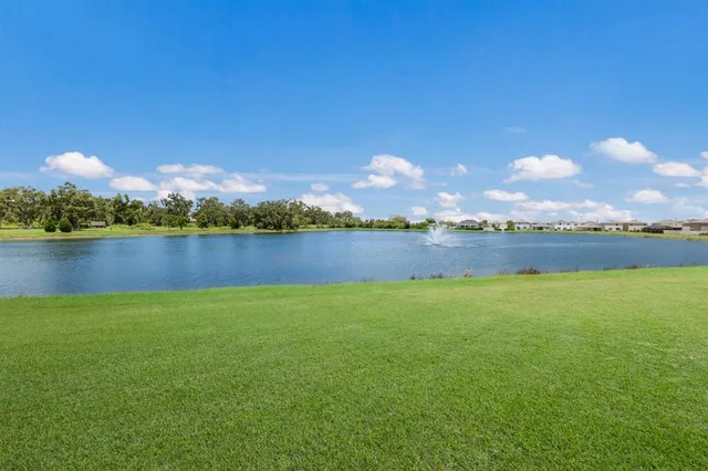 a view of a lake with houses in the back