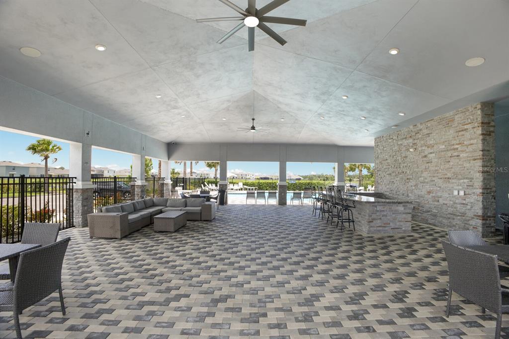2938 Rock Sound Street Bradenton, FL 34208 - Photo 33 of 36 a living room with fireplace furniture and a floor to ceiling window
