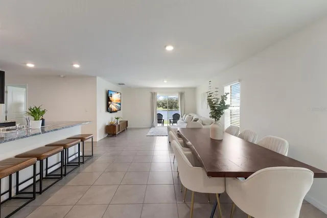 a dining room with furniture and wooden floor