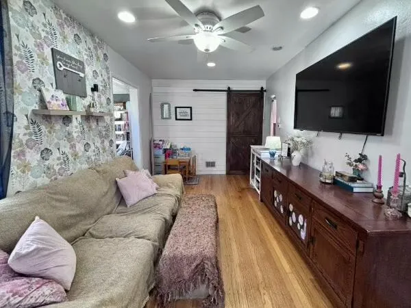 a living room with furniture and a wooden floor