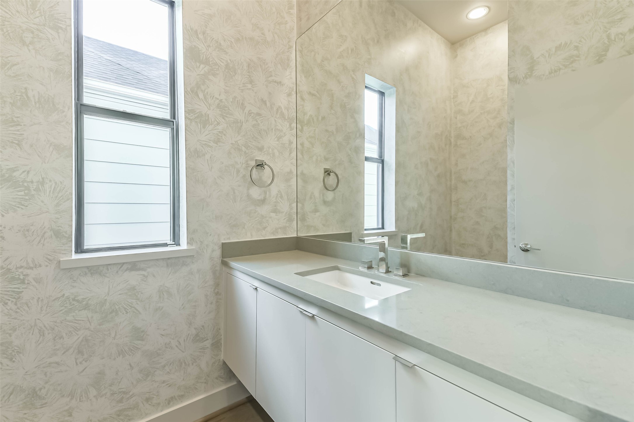 1509 Ruth Street Houston, TX 77004 - Photo 12 of 33 Powder bathroom conveniently located on second floor between living room and dining room. Features include silestone countertops, storage and designer wallpaper.