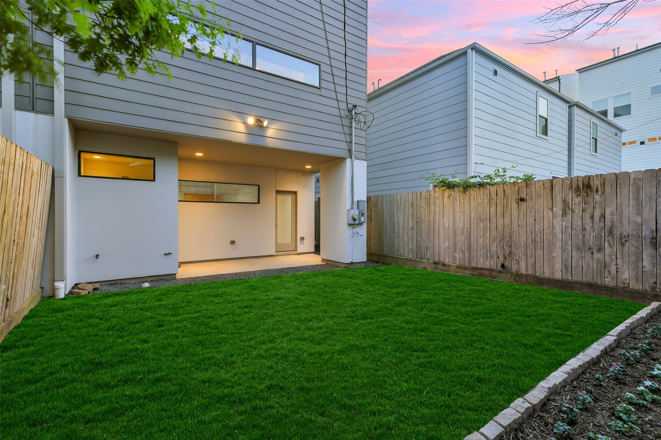 1509 Ruth Street Houston, TX 77004 - Photo 7 of 33 The private backyard is spacious and features freshly landscaped grass and beds! Note the covered patio with recessed lighting with plenty of room for lounging.